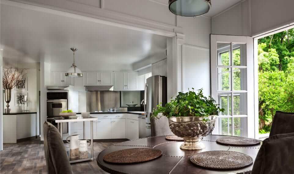 Kitchen with a dining table placed with a centered garden pot on top